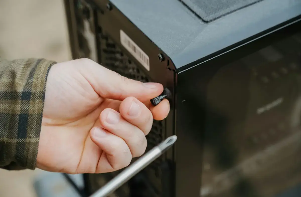 Technician checking a desktop PC interior during a repair